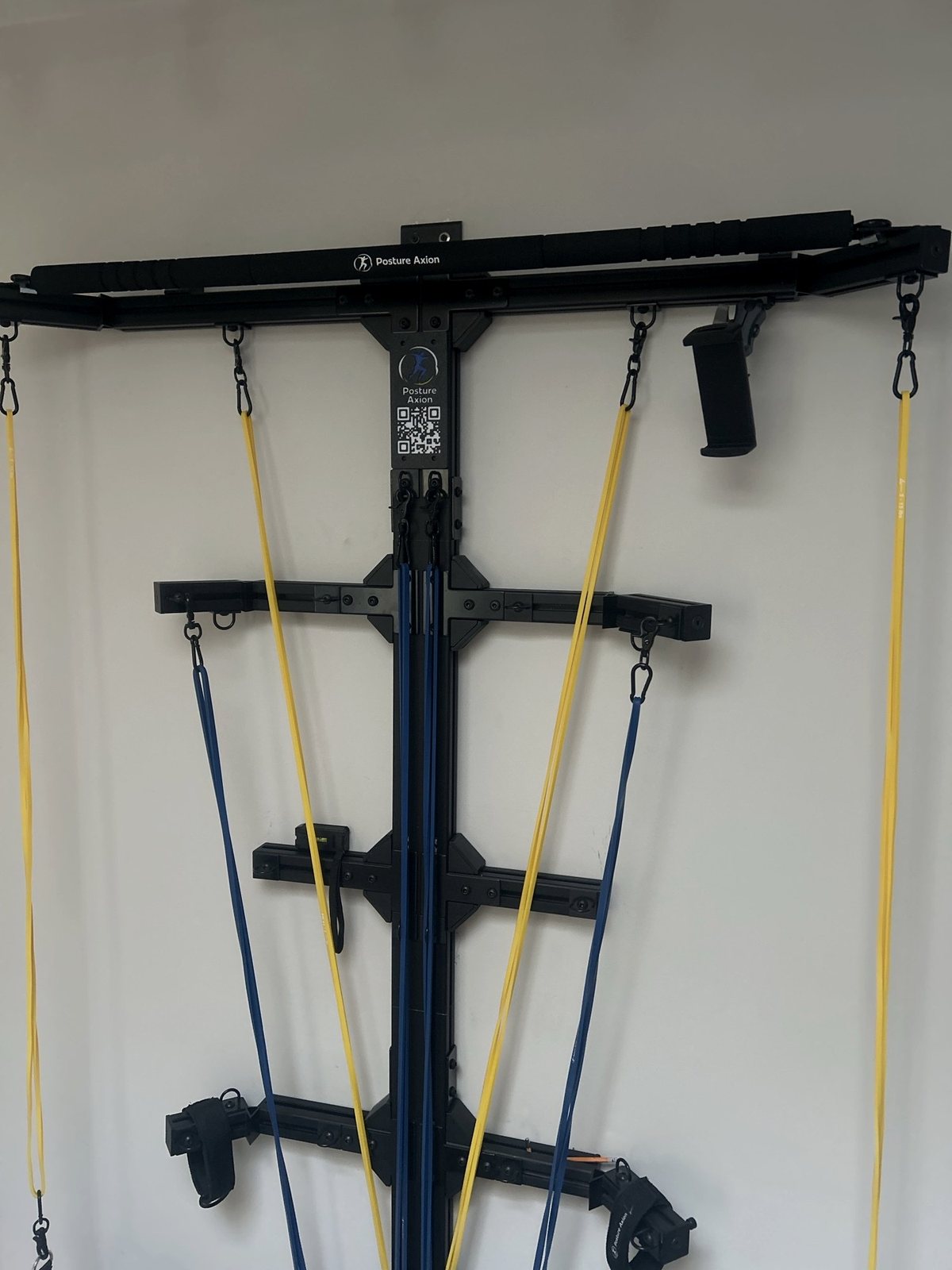 The Posture Axion wall station: top bar, engraved plate, anchor points and resistance bands
